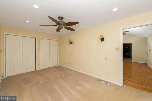 a view of a room with a flat screen tv and refrigerator