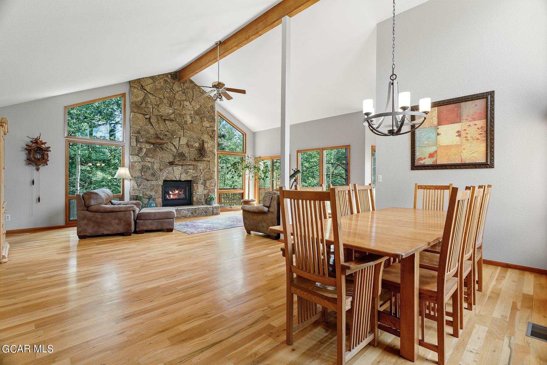 30539 Rand Road Conifer, CO 80433 - Photo 11 of 36 a view of a dining room with furniture window and wooden floor