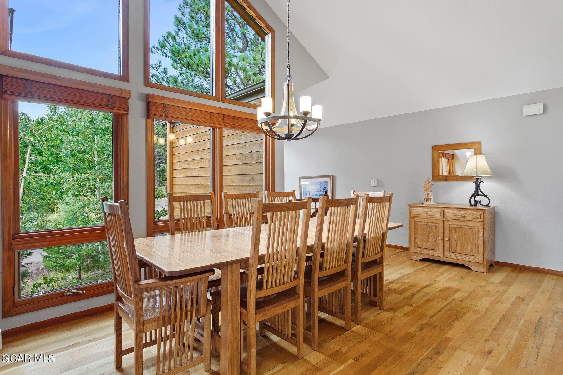 30539 Rand Road Conifer, CO 80433 - Photo 13 of 36 a view of a dining room with furniture window and wooden floor