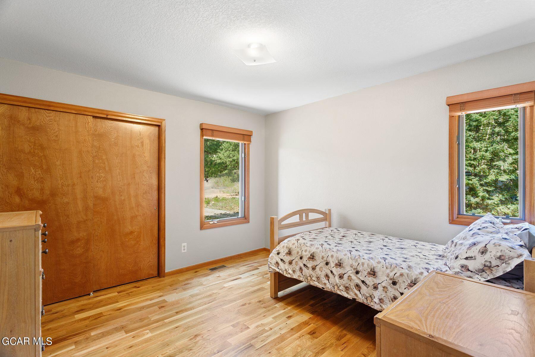 30539 Rand Road Conifer, CO 80433 - Photo 18 of 36 a bedroom with a bed and a window with outer view