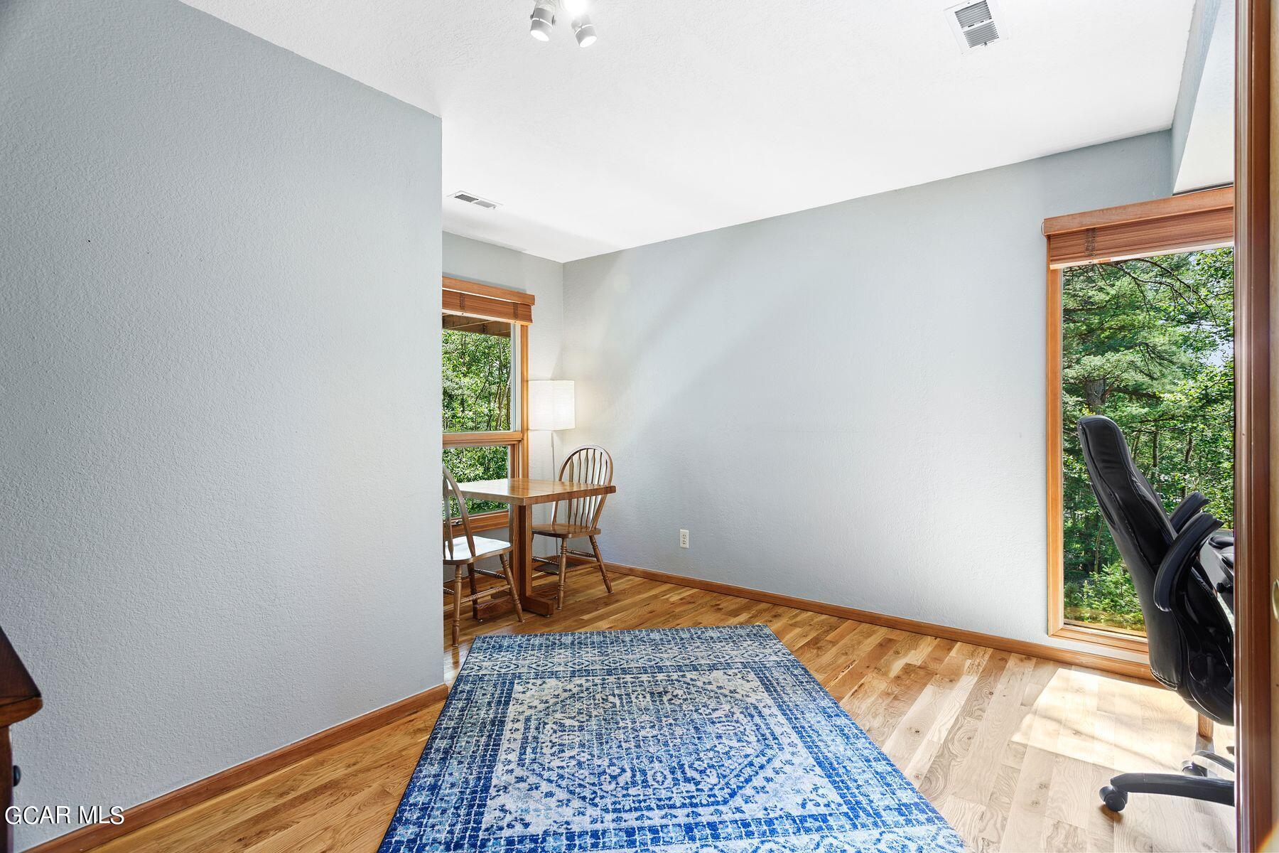 30539 Rand Road Conifer, CO 80433 - Photo 19 of 36 a view of room with window and wooden floor