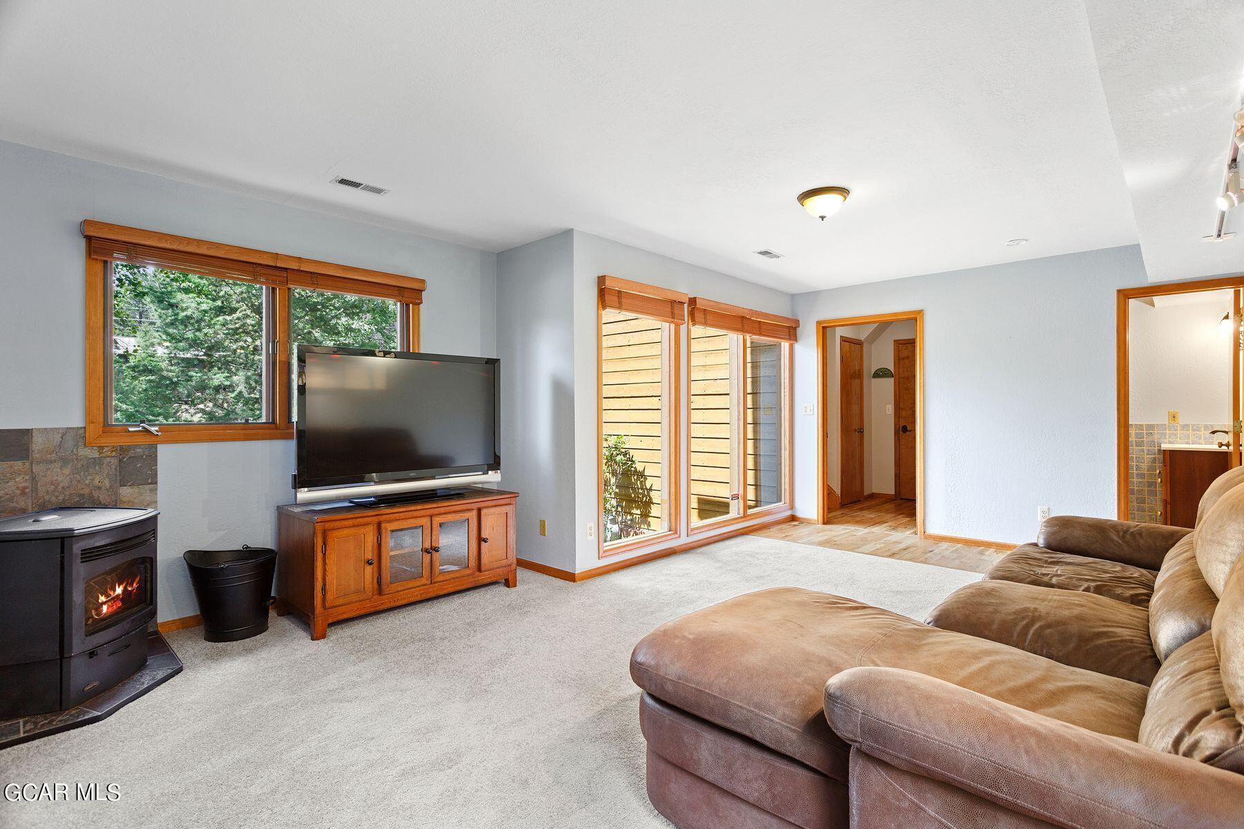 30539 Rand Road Conifer, CO 80433 - Photo 23 of 36 a living room with furniture and a flat screen tv