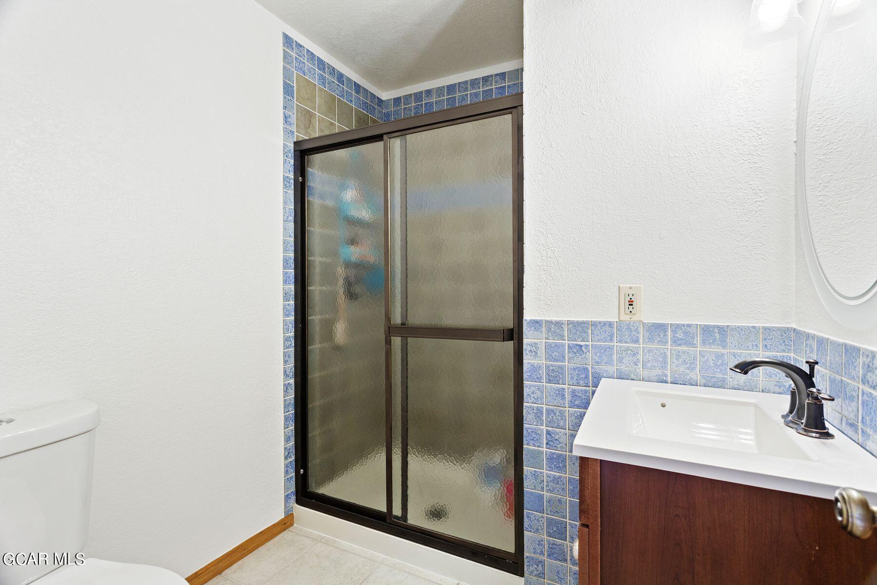 30539 Rand Road Conifer, CO 80433 - Photo 24 of 36 a bathroom with a sink mirror and shower