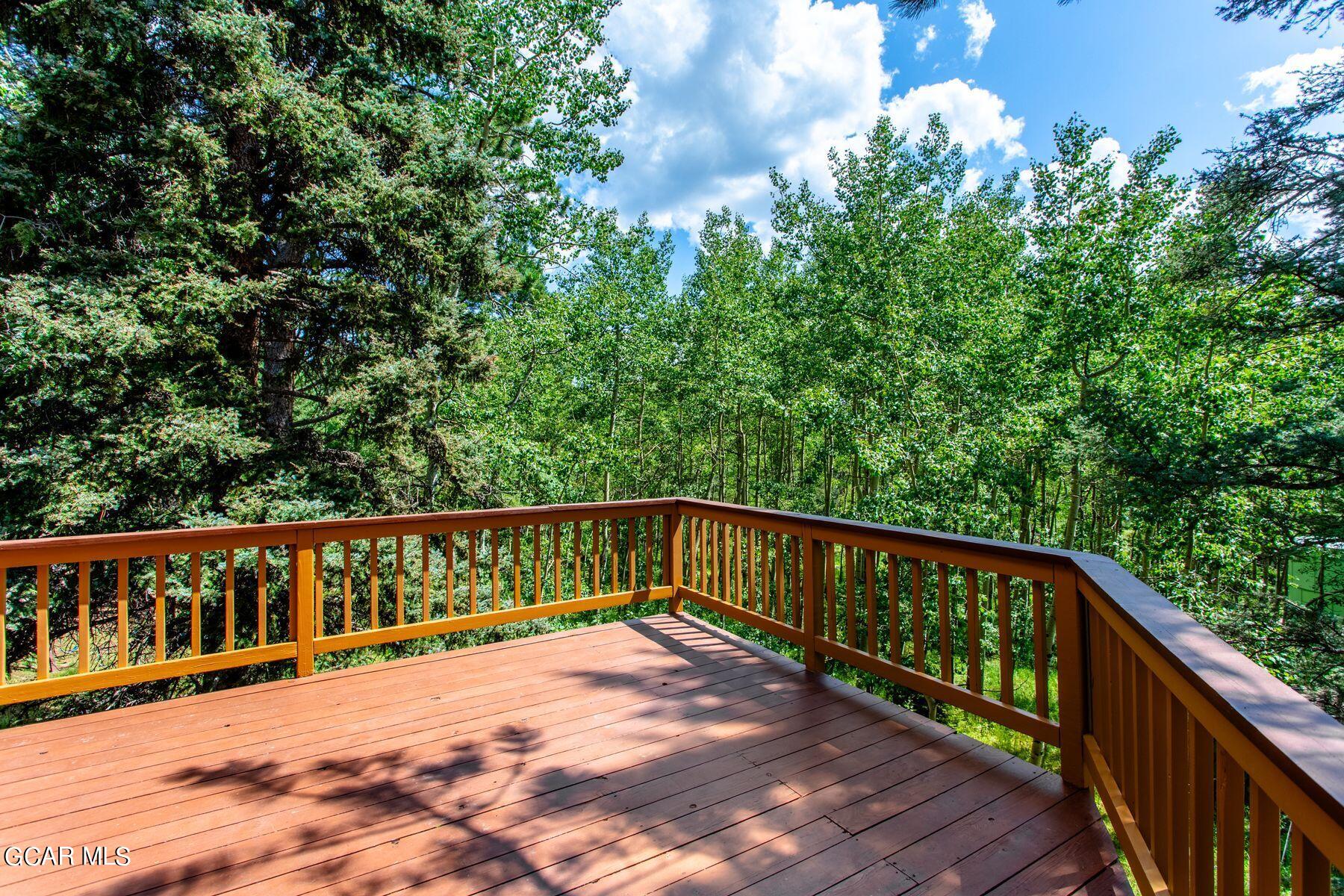 30539 Rand Road Conifer, CO 80433 - Photo 27 of 36 a view of a balcony with wooden floor