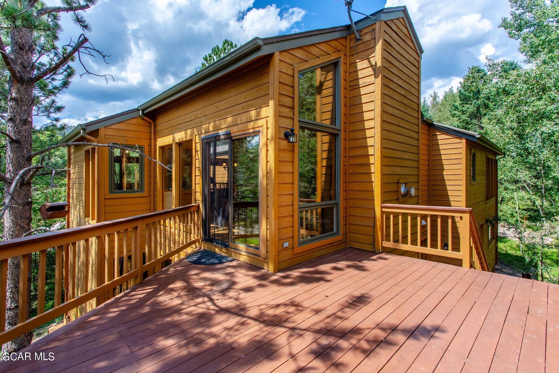 30539 Rand Road Conifer, CO 80433 - Photo 28 of 36 a view of a house with wooden deck