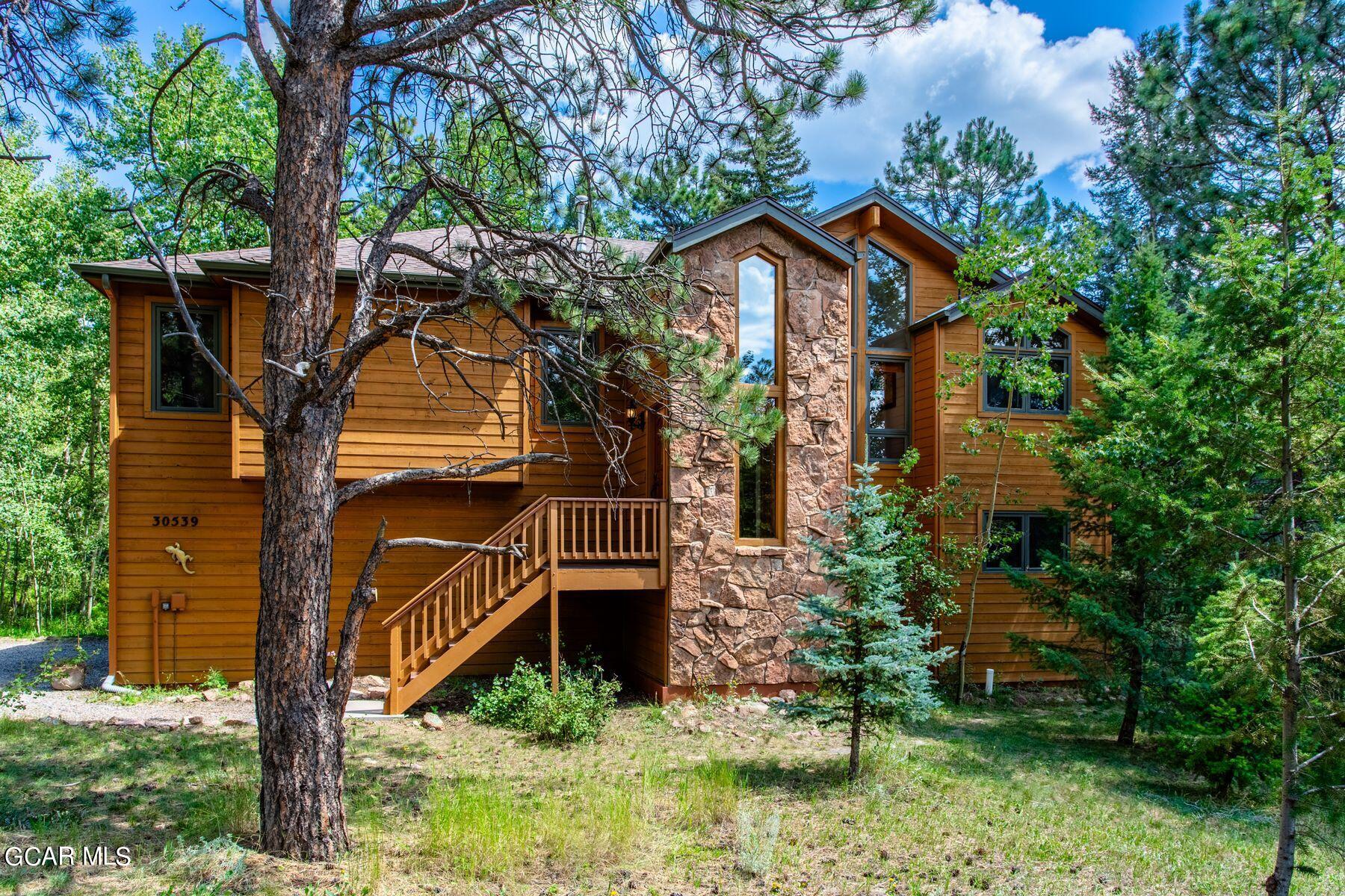 30539 Rand Road Conifer, CO 80433 - Photo 29 of 36 a front view of a house with garden