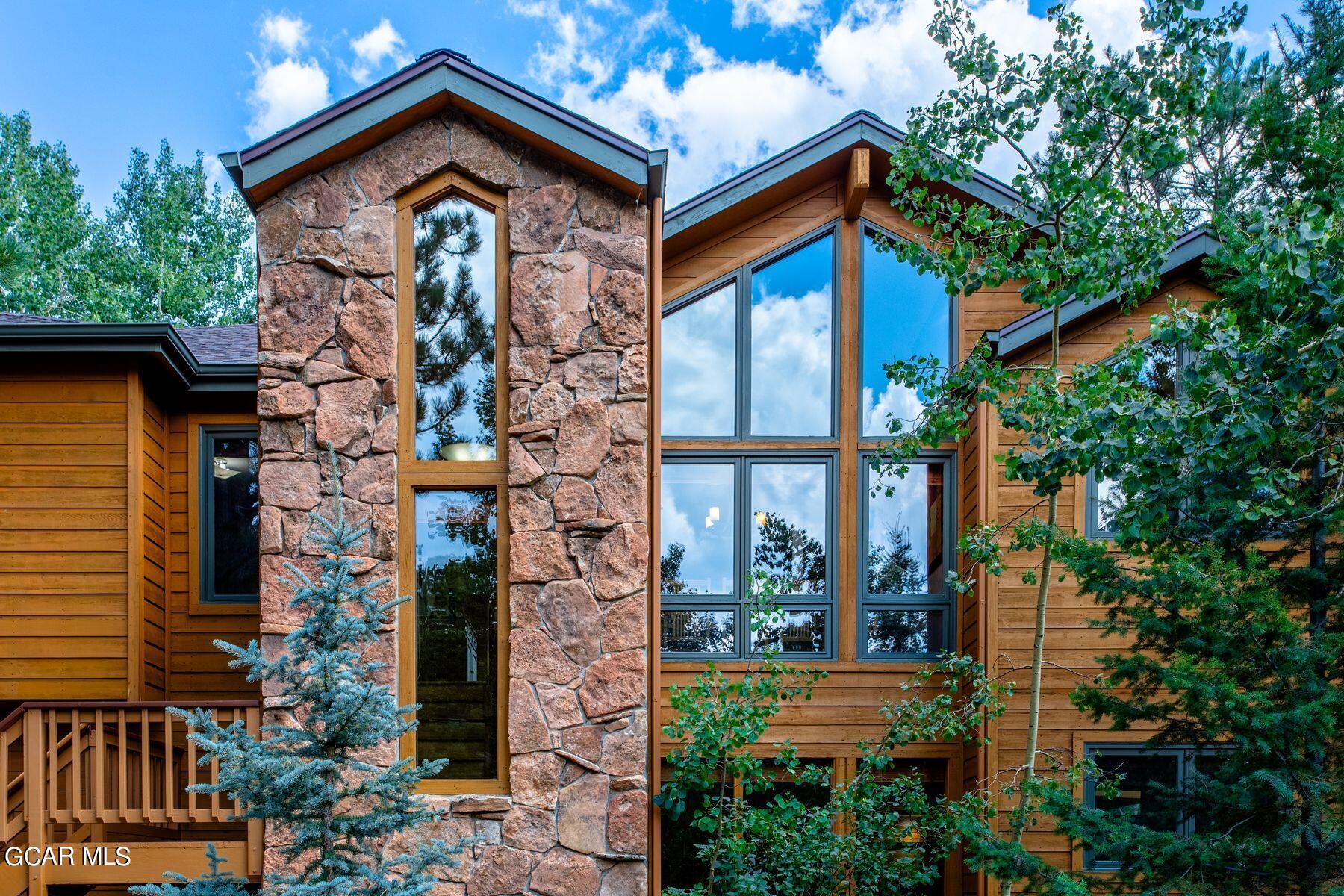30539 Rand Road Conifer, CO 80433 - Photo 6 of 36 a front view of a house with a yard