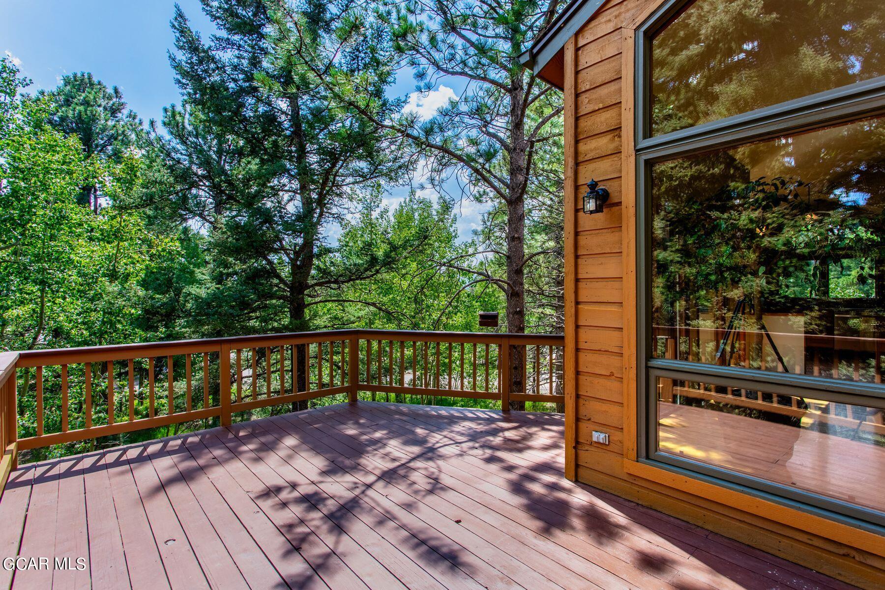 30539 Rand Road Conifer, CO 80433 - Photo 7 of 36 a view of balcony with wooden floor