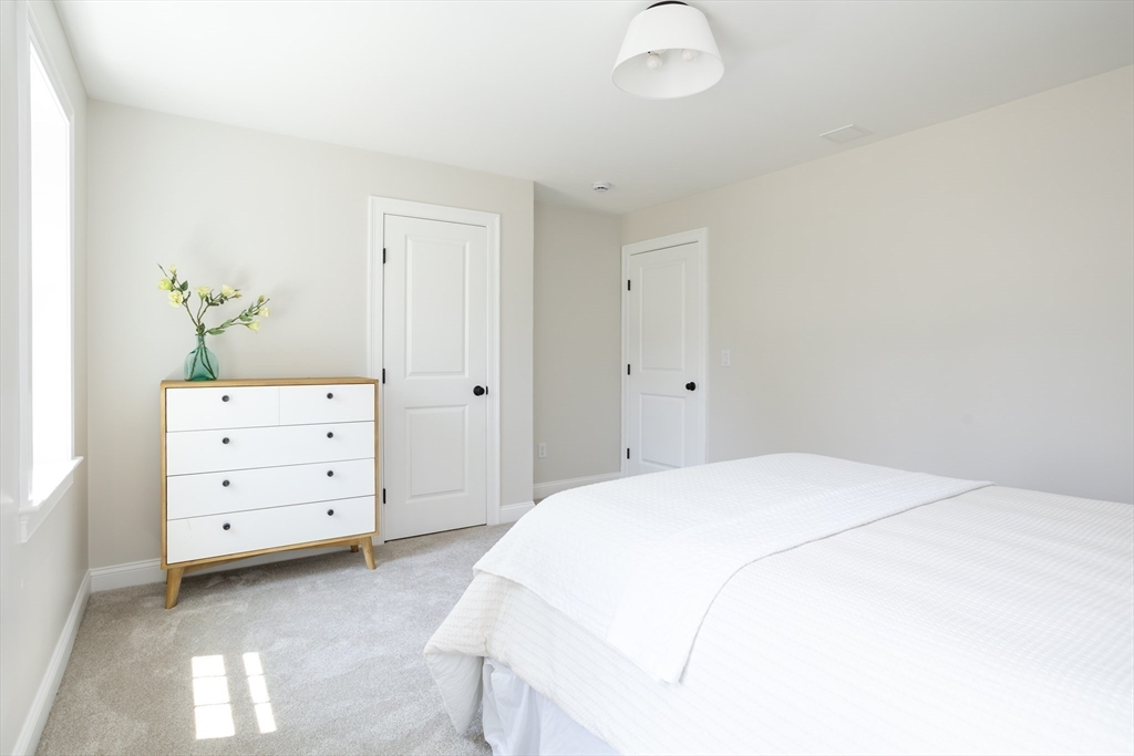 65 Great Neck Road Wareham, MA 02571 - Photo 26 of 41 a bedroom with a bed and a dresser