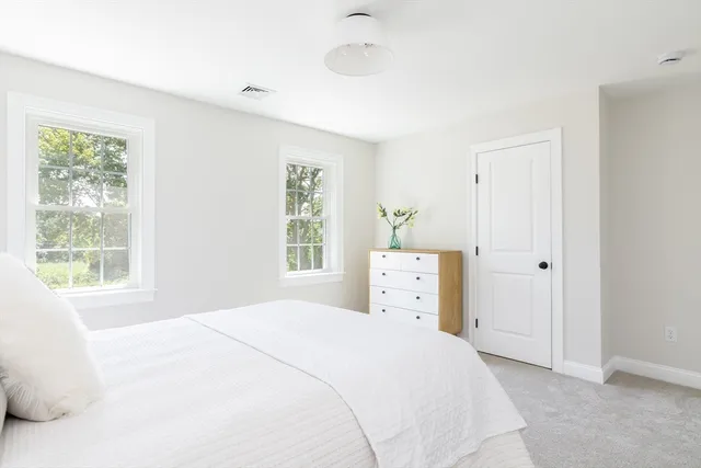 a bedroom with a bed and a night stand