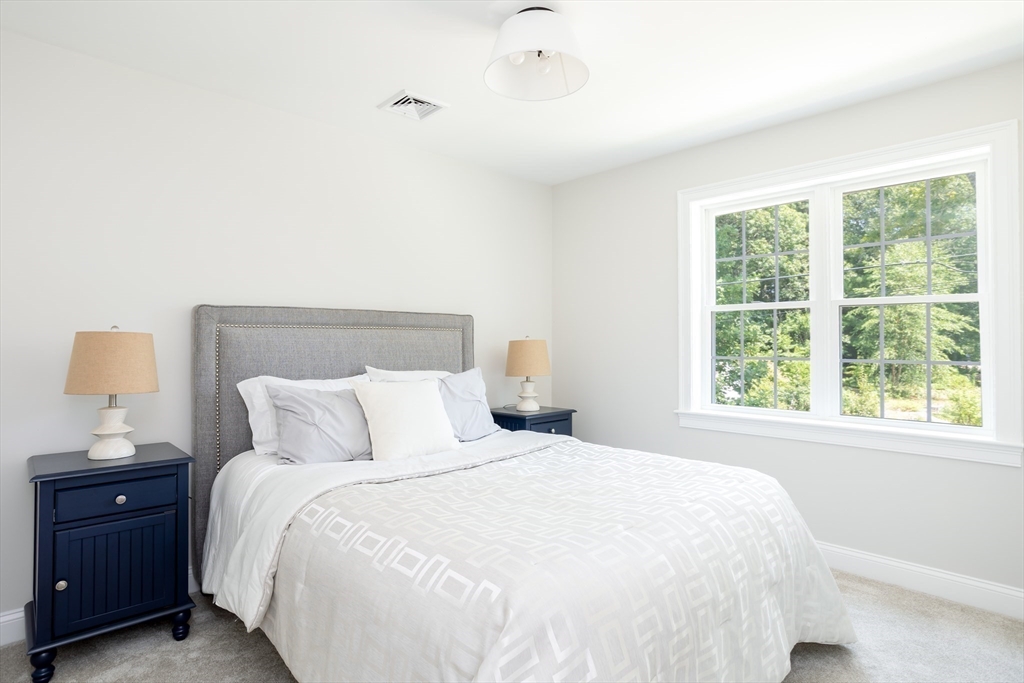 65 Great Neck Road Wareham, MA 02571 - Photo 28 of 41 a bedroom with a bed and a night stand