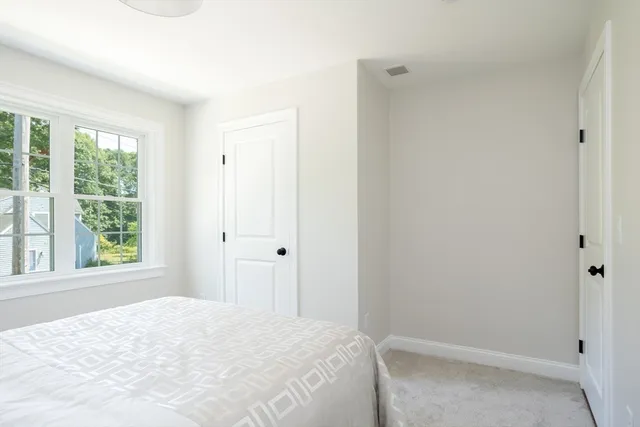 a bedroom with a bed and a mirror