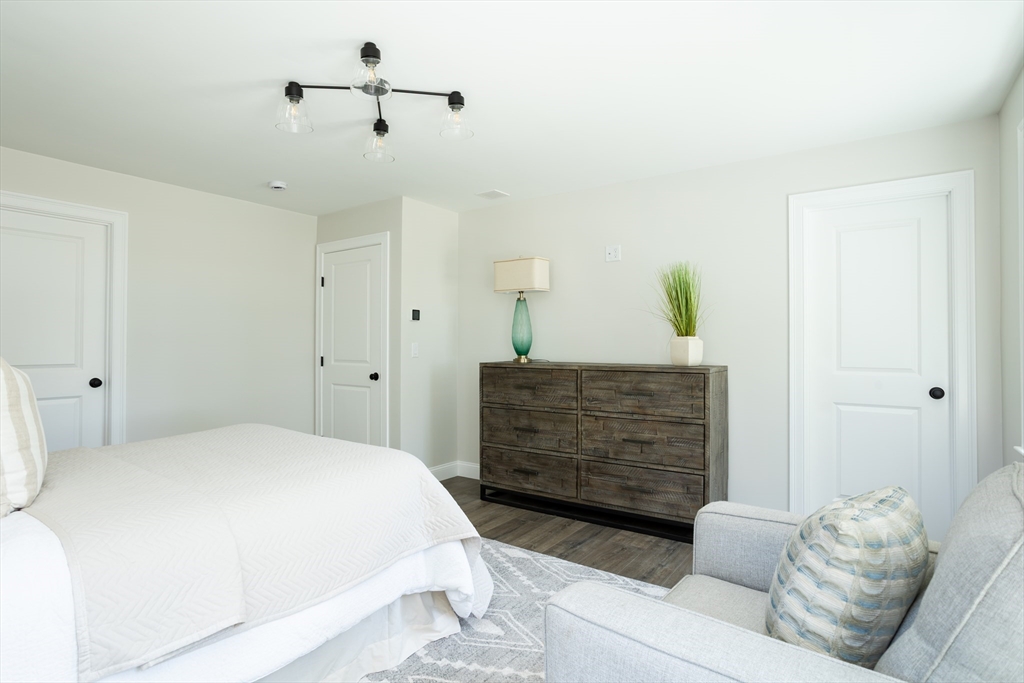 65 Great Neck Road Wareham, MA 02571 - Photo 33 of 41 a bedroom with a bed and a chandelier