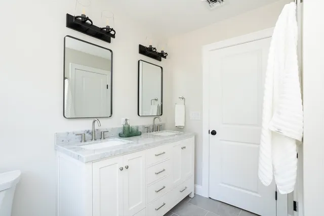 a bathroom with a tub shower vanity and a sink