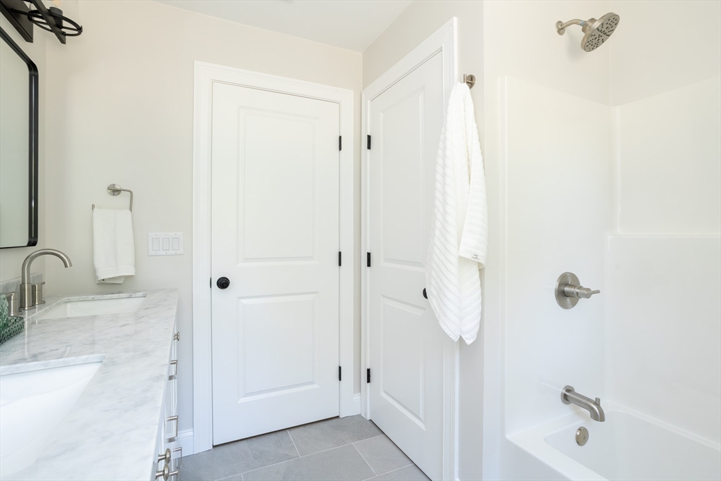 65 Great Neck Road Wareham, MA 02571 - Photo 37 of 41 a bathroom with a tub shower vanity and a sink
