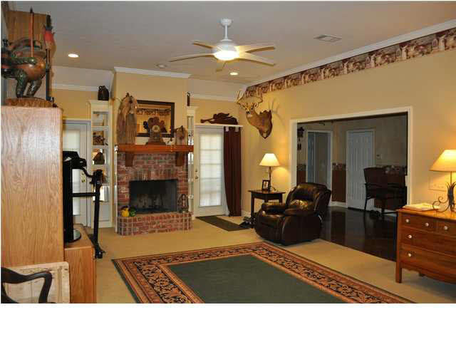 356 Stokes Road Flora, MS 39071 - Photo 11 of 24 Den with gas log fireplace and bookcases