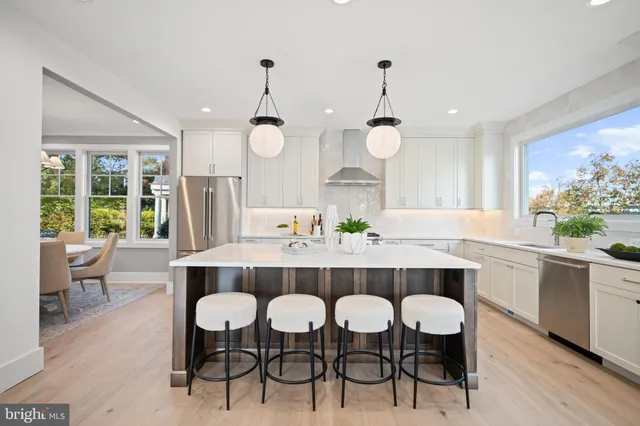 a view of a dining room and a kitchen with a table chairs