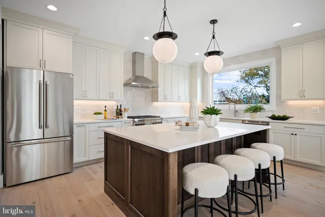 a kitchen with a center island and a refrigerator