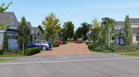 a view of a street with cars parked on the road