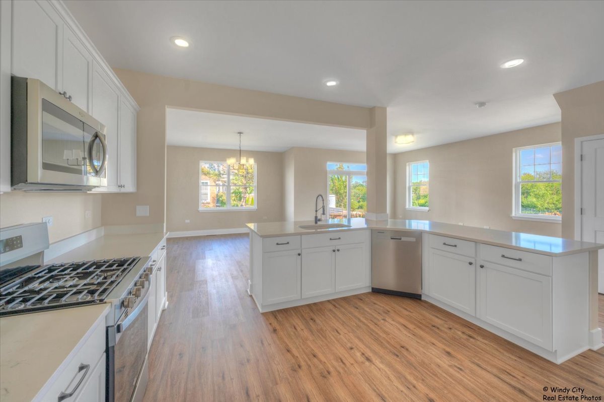 425 Haber Road, Unit 6 Cary, IL 60013 - Photo 6 of 18 a kitchen with cabinets a sink and appliances