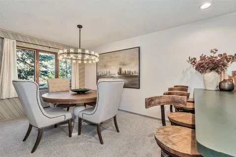 a view of a dining room with furniture window and outside view
