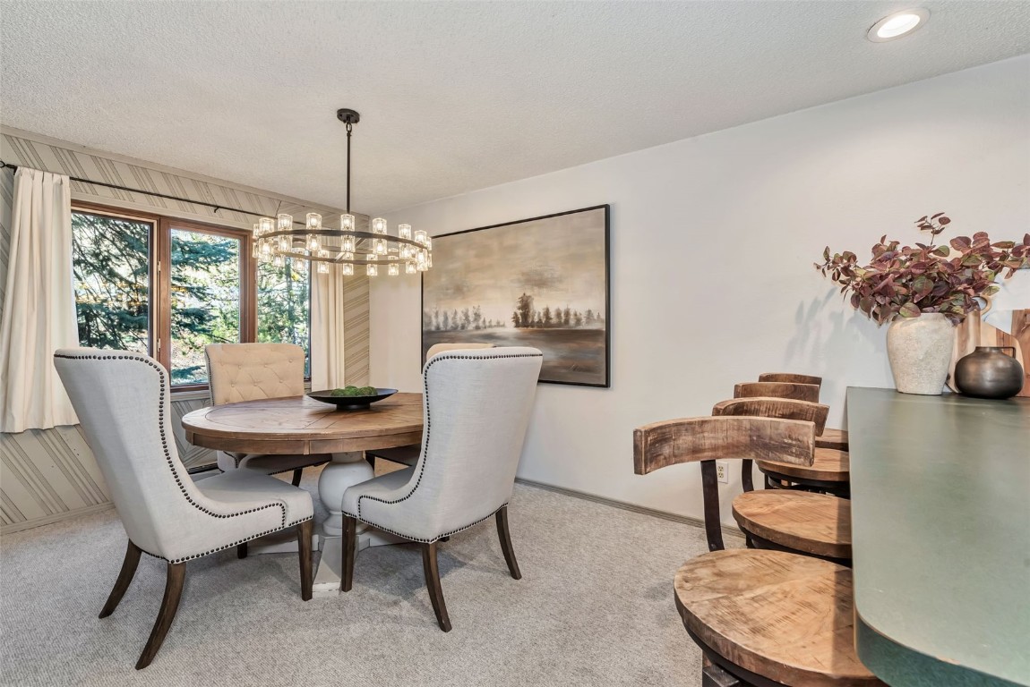 2617 Burgess Creek Road, Unit 102 Steamboat Springs, CO 80487 - Photo 11 of 38 a view of a dining room with furniture window and outside view