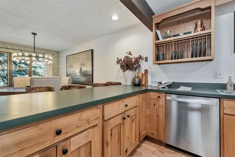 a kitchen with stainless steel appliances granite countertop a sink and a stove