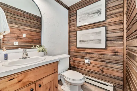 a bathroom with a sink a toilet and mirror