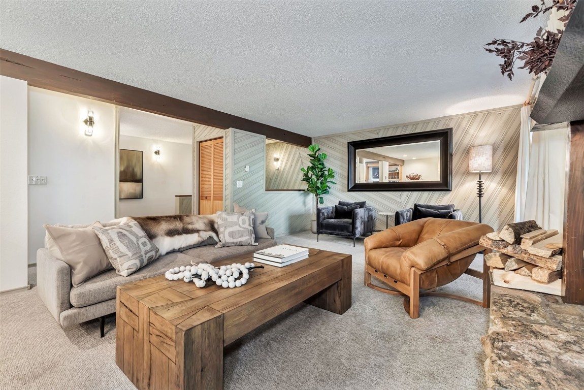 2617 Burgess Creek Road, Unit 102 Steamboat Springs, CO 80487 - Photo 8 of 38 a living room with furniture and a fireplace