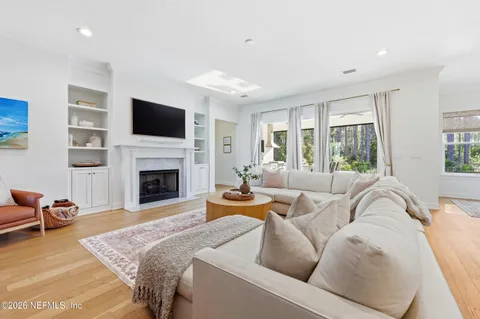 a view of a dining room with furniture large windows and wooden floor