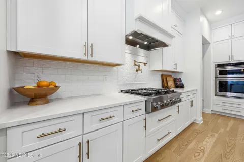 a spacious bathroom with a sink and a mirror