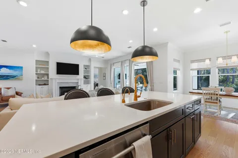 a bathroom with a granite countertop sink mirror and a bathtub