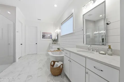 a spacious bedroom with a bed a couch and a window