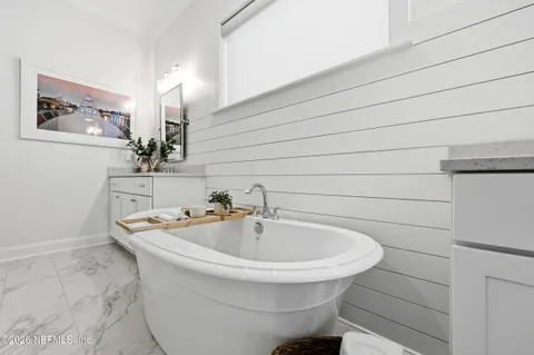 a bedroom with a large bed and a dresser