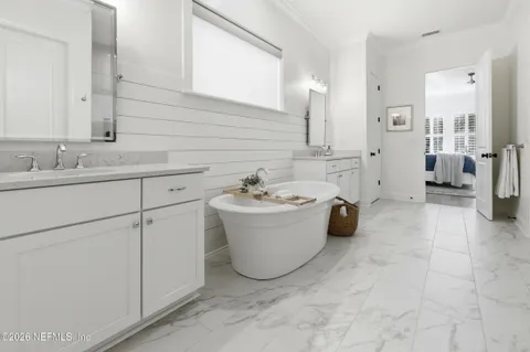 a bathroom with a granite countertop sink a large mirror and a shower