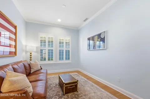 an aerial view of a house with swimming pool and large trees