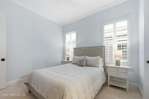 an aerial view of a house with swimming pool and outdoor seating