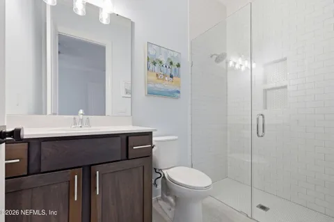 an aerial view of a swimming pool with outdoor seating