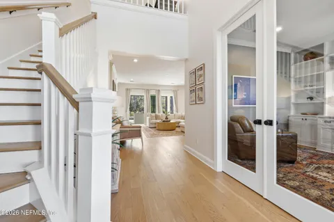 a living room with furniture potted plant and a large window