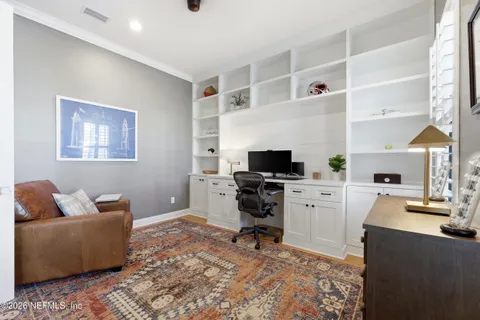 a living room with furniture and a view of kitchen
