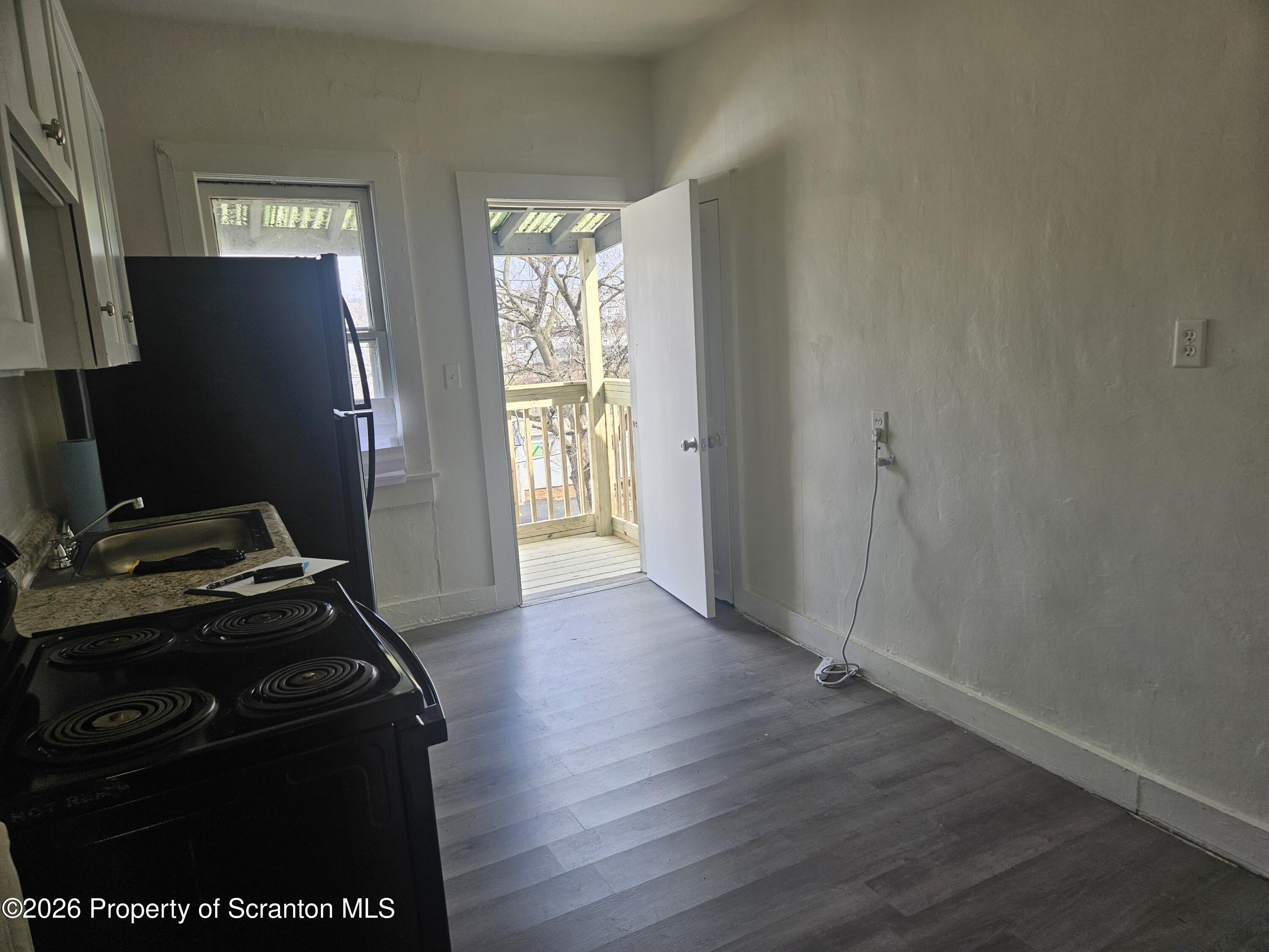 715 Moosic Street, Unit 5 Scranton, PA 18505 - Photo 3 of 14 a view of a room with wooden floor and a fireplace