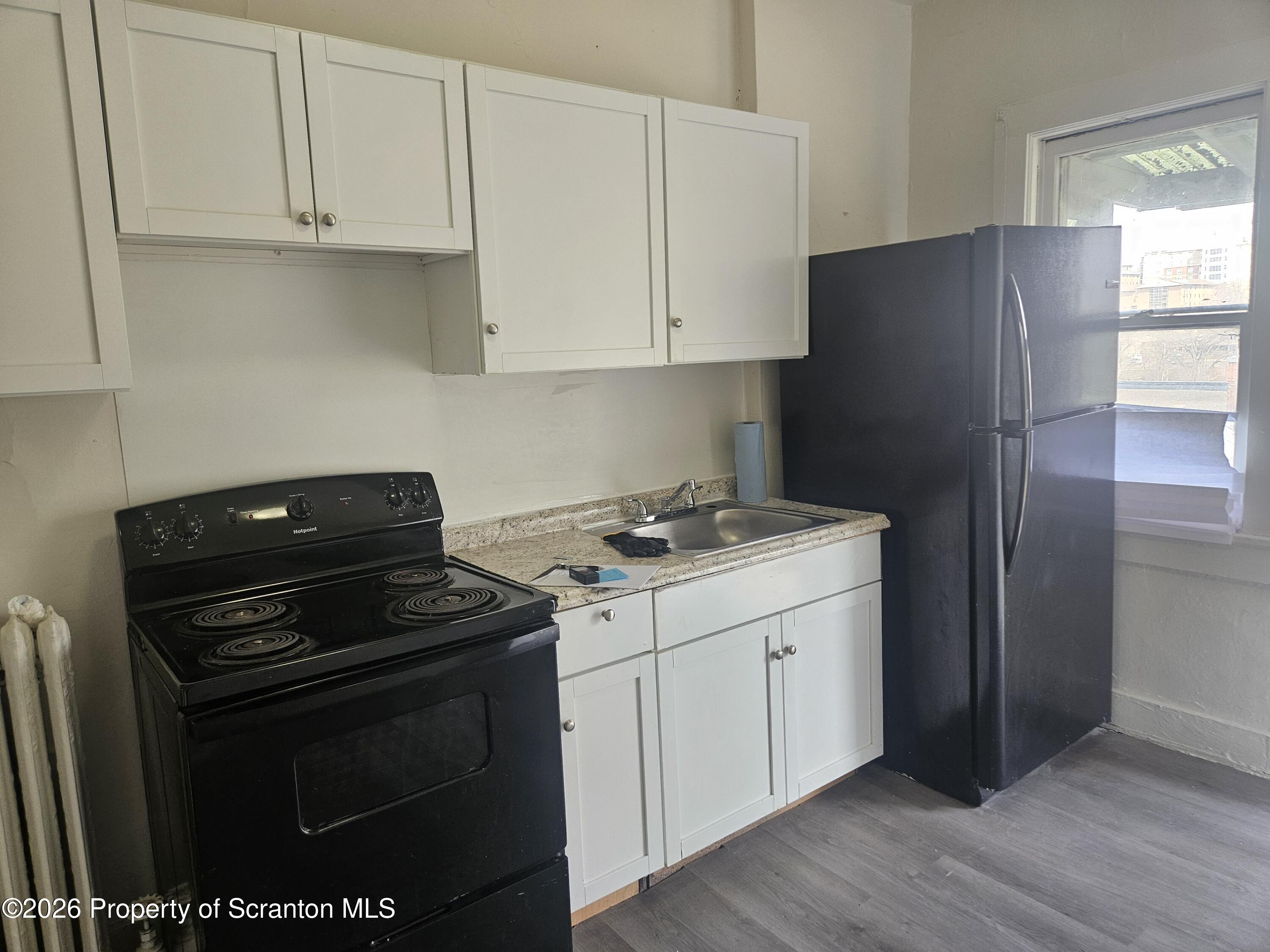 715 Moosic Street, Unit 5 Scranton, PA 18505 - Photo 4 of 14 a kitchen with a sink stove and refrigerator