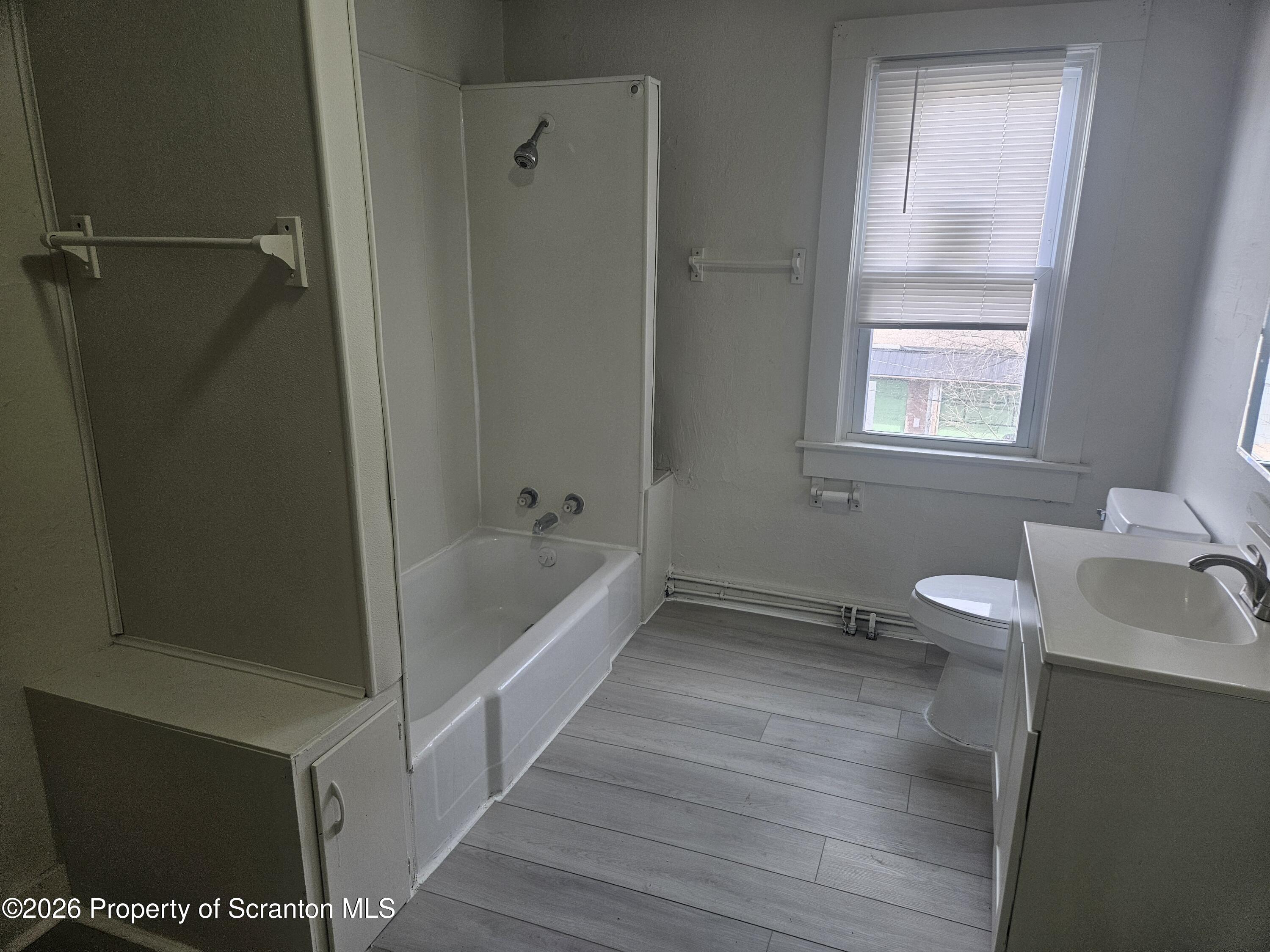 715 Moosic Street, Unit 5 Scranton, PA 18505 - Photo 6 of 14 a bathroom with a sink a toilet and shower