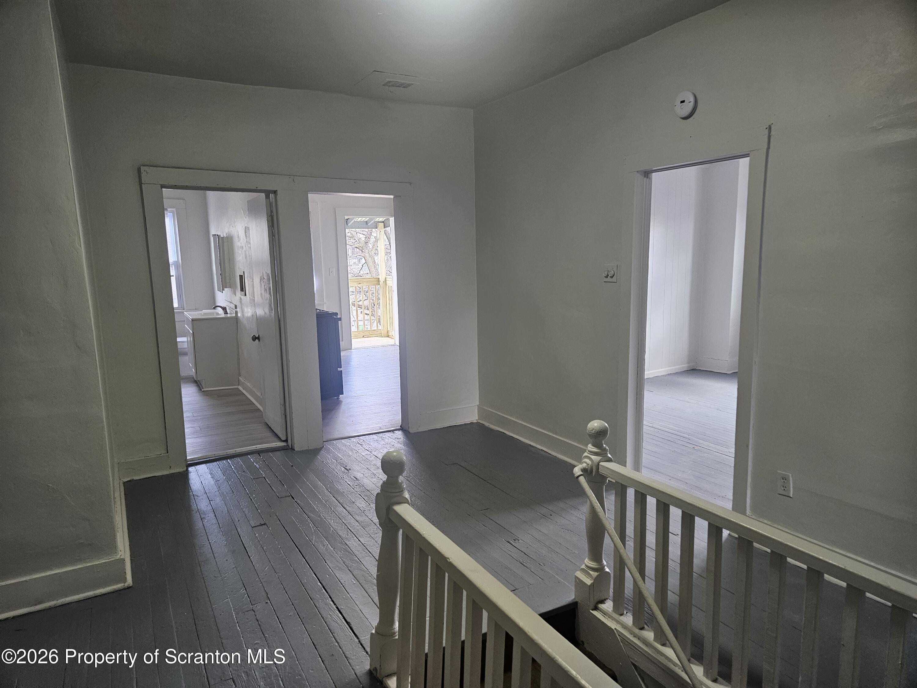 715 Moosic Street, Unit 5 Scranton, PA 18505 - Photo 8 of 14 a view of a hallway with wooden floor and staircase