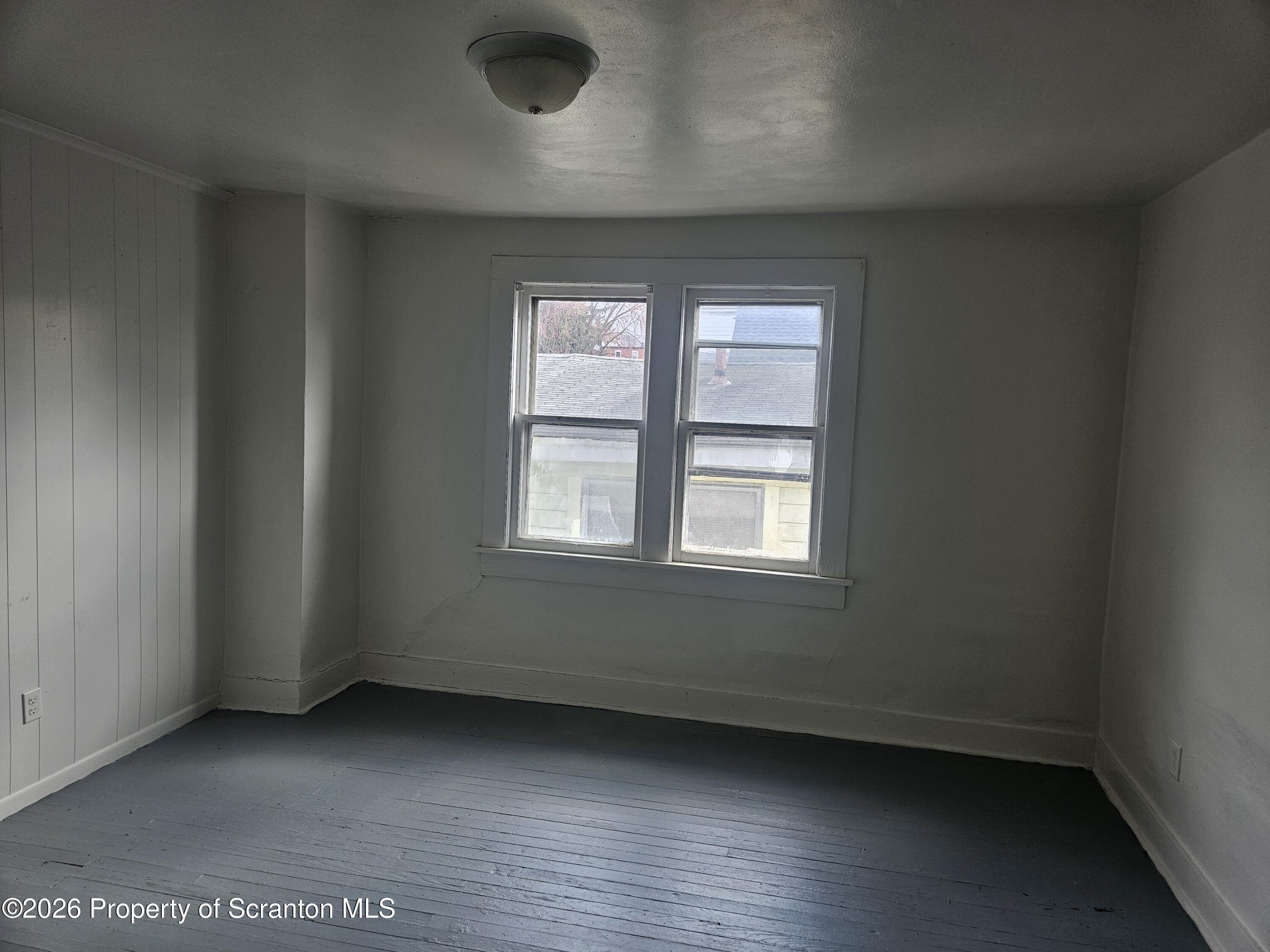 715 Moosic Street, Unit 5 Scranton, PA 18505 - Photo 9 of 14 an empty room with wooden floor and windows
