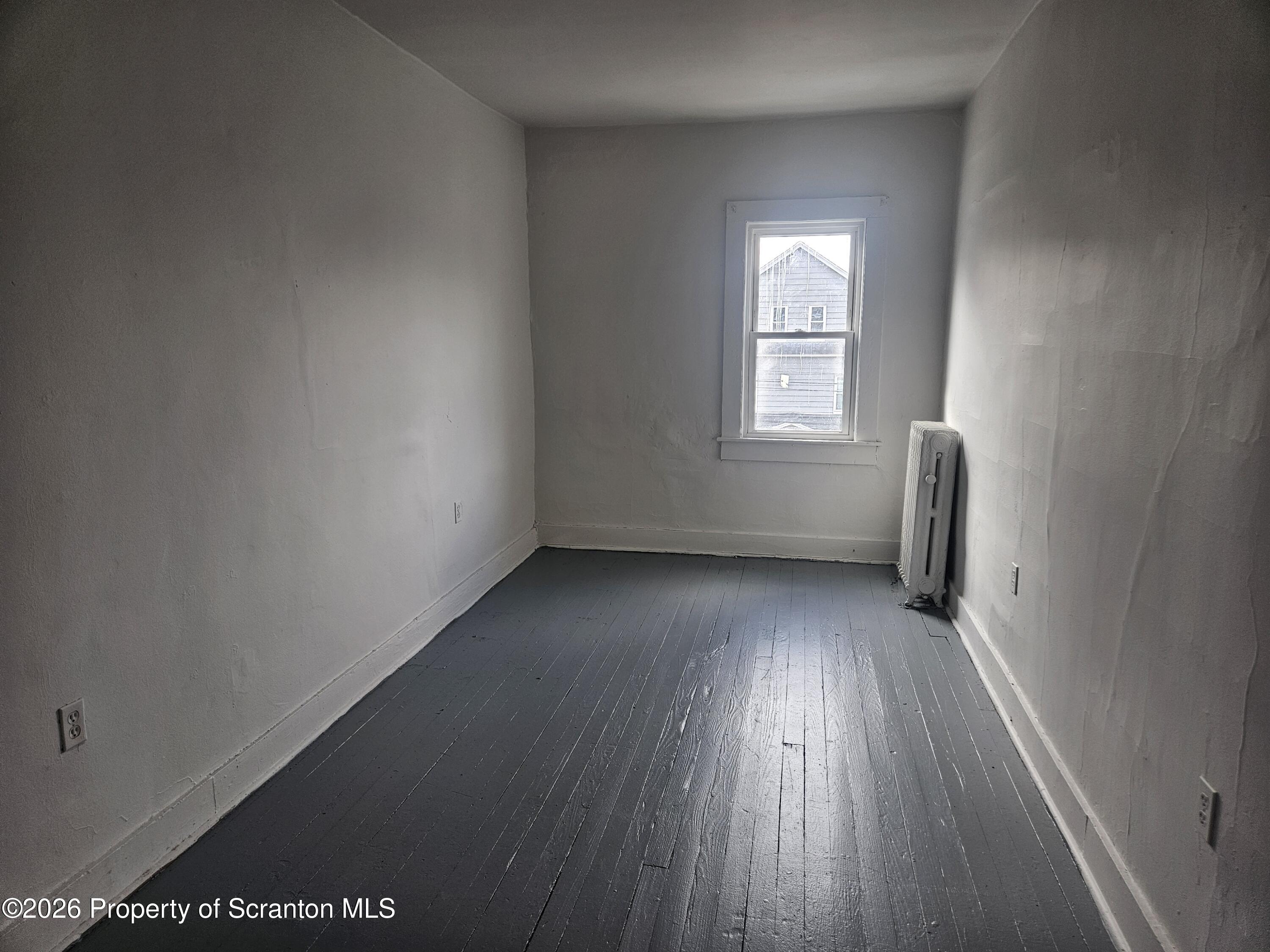 715 Moosic Street, Unit 5 Scranton, PA 18505 - Photo 10 of 14 an empty room with wooden floor and windows