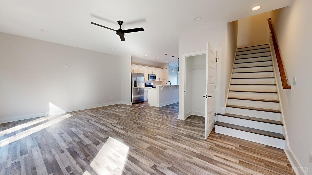 128 Allure Drive Rustburg, VA 24588 - Photo 12 of 30 a view of a room with wooden floor and a ceiling fan