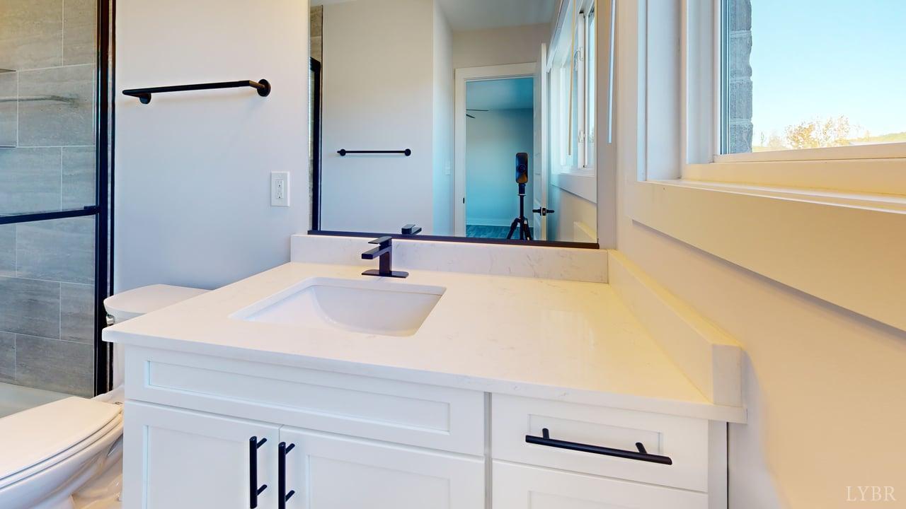 128 Allure Drive Rustburg, VA 24588 - Photo 22 of 30 a bathroom with a sink and a mirror