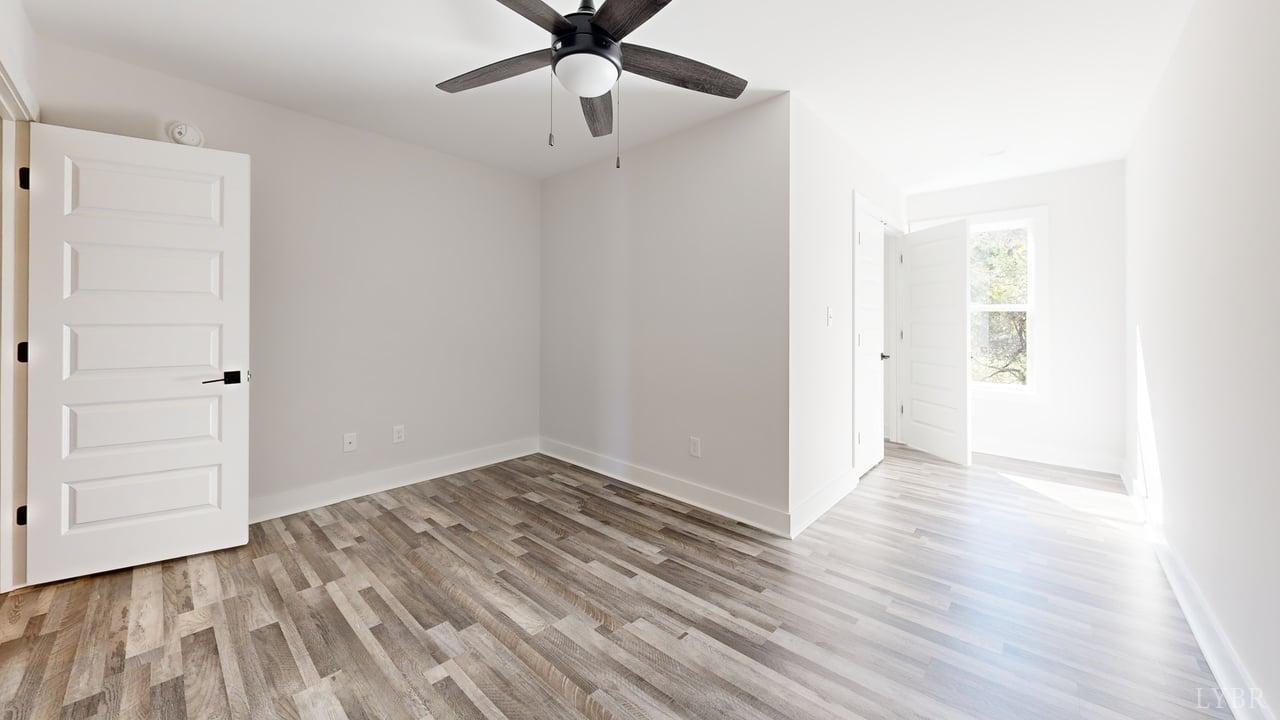 128 Allure Drive Rustburg, VA 24588 - Photo 27 of 30 an empty room with wooden floor closet and ceiling fan
