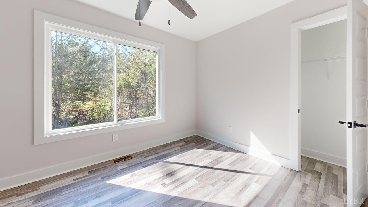 128 Allure Drive Rustburg, VA 24588 - Photo 28 of 30 a view of empty room with wooden floor and fan